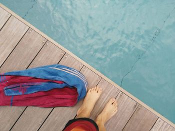 Low section of man standing at poolside