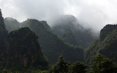 Scenic view of mountains against cloudy sky