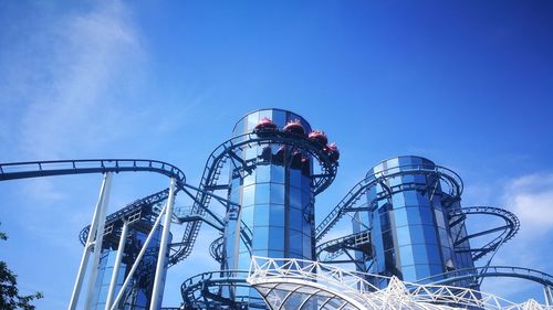 Low angle view of factory against clear blue sky