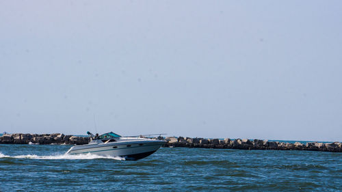 Boat in sea against clear sky