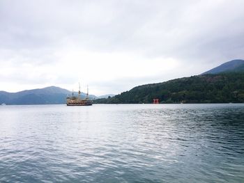 Ship sailing on sea against sky