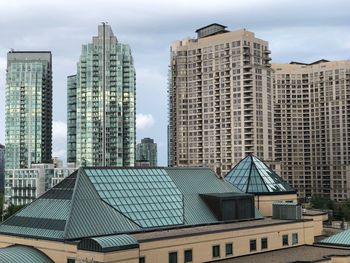 Modern buildings in city against sky