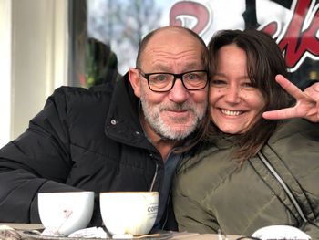 Portrait of man and woman sitting at table