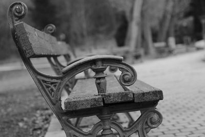 Close-up of old bench in park