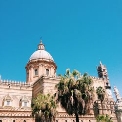 Low angle view of palermo cathedral against clear blue sky