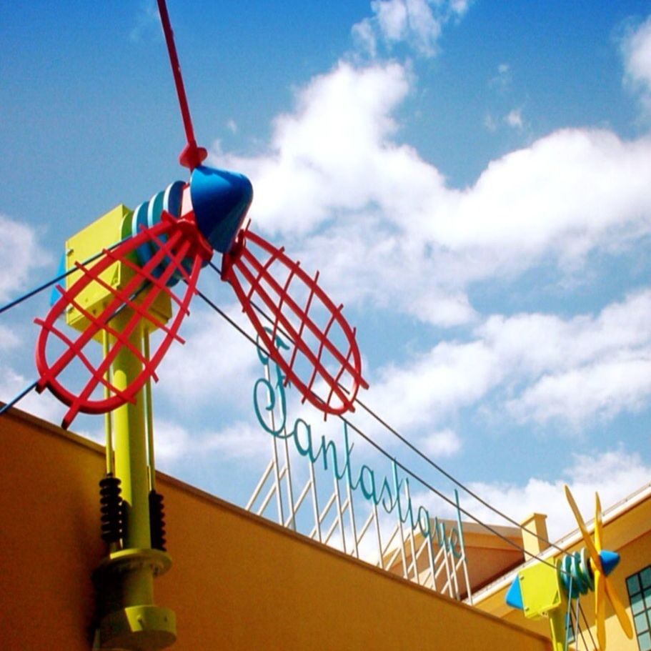 low angle view, sky, cloud - sky, built structure, blue, cloudy, cloud, amusement park, metal, architecture, multi colored, railing, metallic, day, outdoors, arts culture and entertainment, amusement park ride, no people, lighting equipment, building exterior