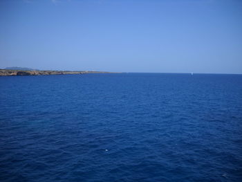 Scenic view of sea against clear blue sky