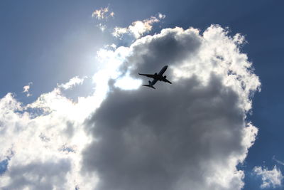 Low angle view of airplane flying in sky