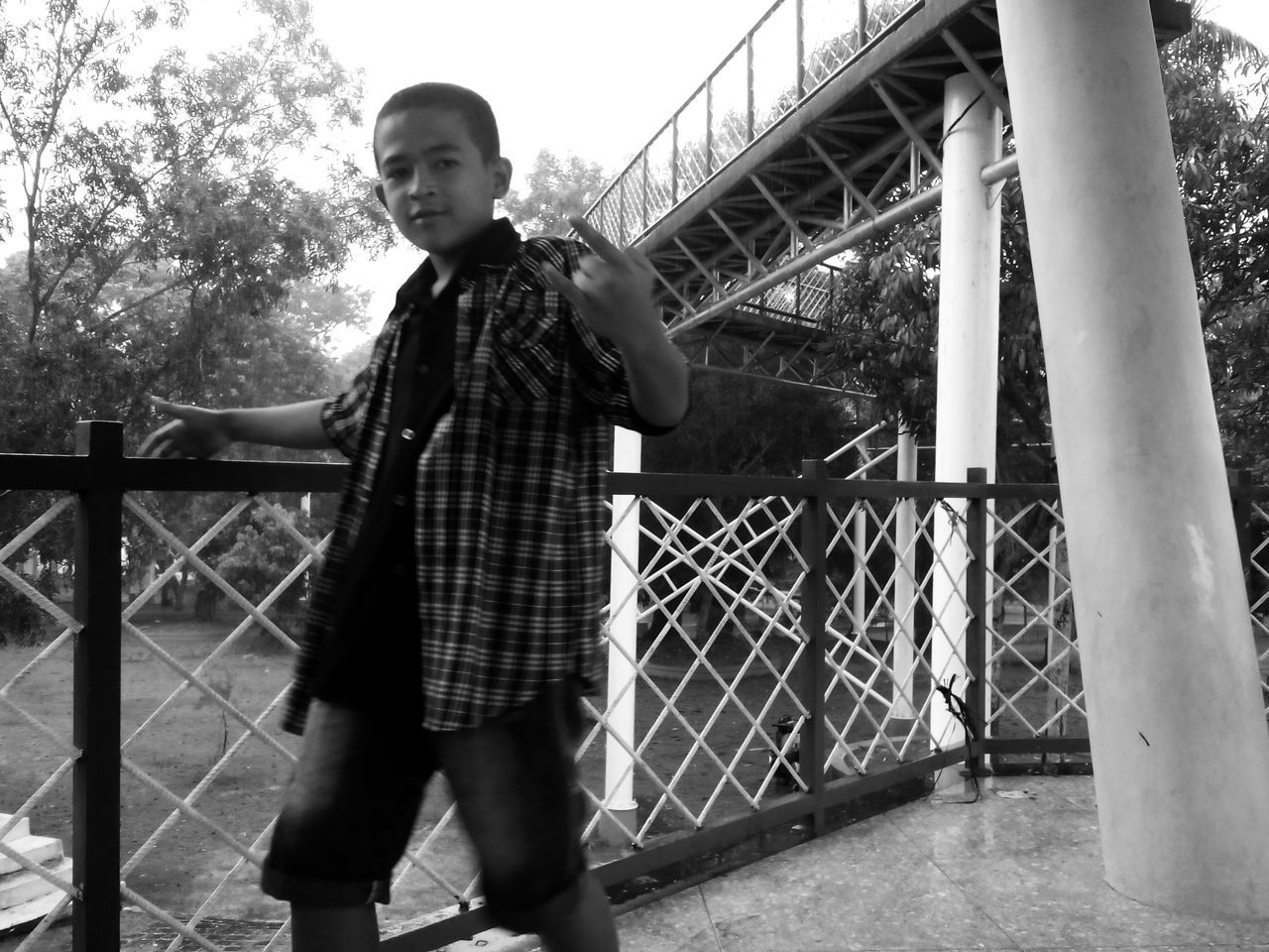 FULL LENGTH PORTRAIT OF BOY STANDING ON LANDSCAPE AGAINST TREES