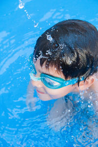 Portrait of boy swimming in pool