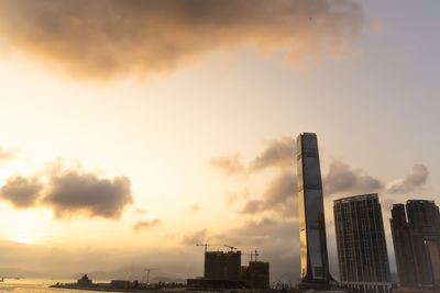 Low angle view of buildings against sky during sunset