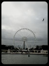 Ferris wheel against cloudy sky