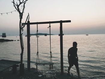 Man standing by sea against sky