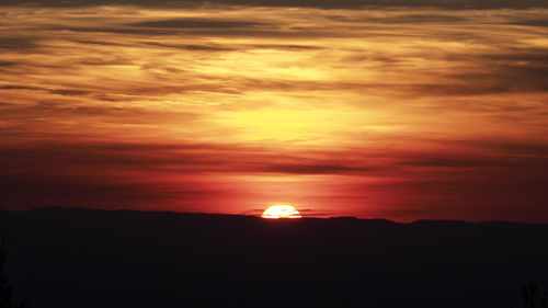 Scenic view of silhouette landscape against romantic sky at sunset