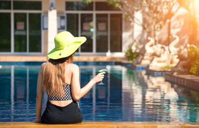 Rear view of woman in swimming pool