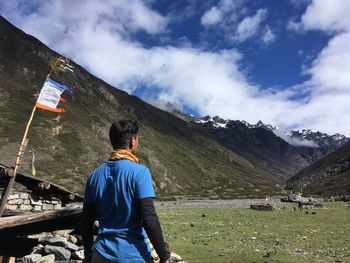 Man walking against mountains in sunny day