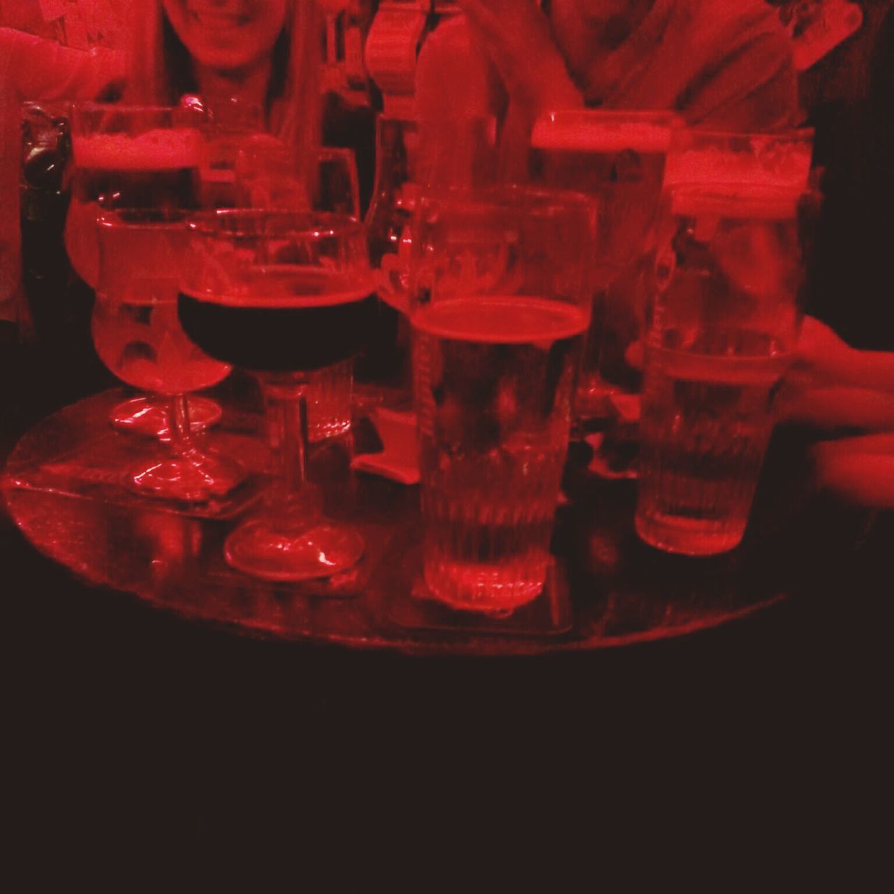 indoors, red, food and drink, still life, drink, table, close-up, refreshment, glass - material, drinking glass, candle, freshness, no people, illuminated, transparent, wineglass, black background, glass, focus on foreground, alcohol