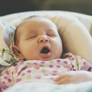 Close-up of baby lying on bed