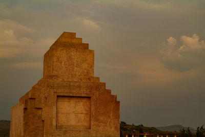 Low angle view of old building against sky during sunset