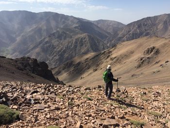 Rear view of man walking on mountain