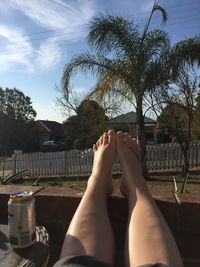 Low section of woman relaxing in swimming pool