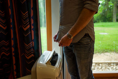 Midsection of man standing at home