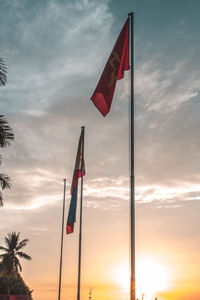 Low angle view of flag against sky during sunset