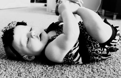 Low section of woman lying on floor