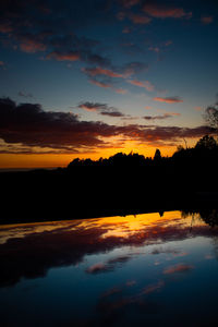 Scenic view of lake against romantic sky at sunset