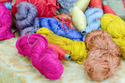 Close-up of multi colored woolen spoons on table