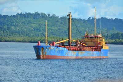 Ship sailing on sea against sky