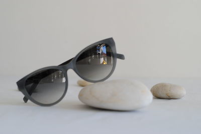 Close-up of sunglasses on table against white background