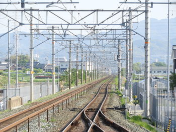 Railroad tracks by electricity pylon