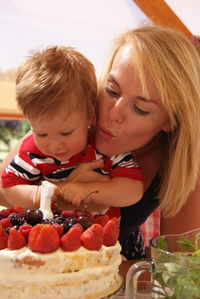 Close-up of woman with chocolate cake