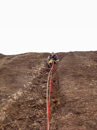 Person skiing on desert against sky