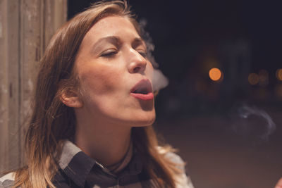 Close-up of woman smoking cigarette