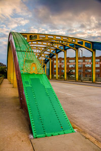 Graffiti on bridge against sky