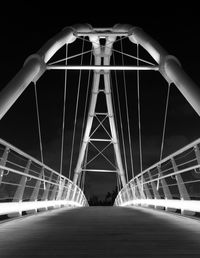 Low angle view of illuminated bridge against sky at night