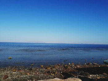 Scenic view of sea against clear blue sky