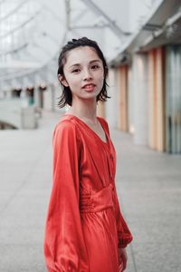 Portrait of smiling young woman standing outdoors