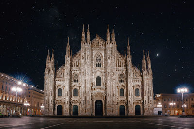 Facade of cathedral against sky at night