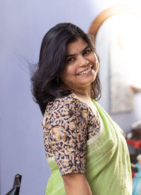 Portrait of a beautiful indian woman in green saree