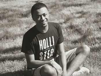 High angle portrait of man sitting on grass