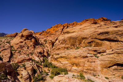 Scenic view of mountains against clear blue sky