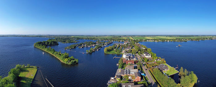 High angle view of city against blue sky