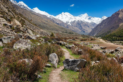 Scenic view of stream amidst rocks against sky