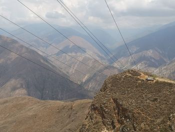 Aerial view of mountain range against cloudy sky