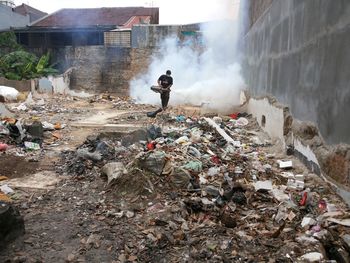 Man standing by garbage