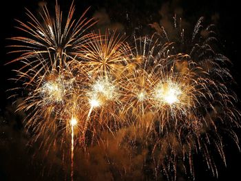 Low angle view of firework display at night