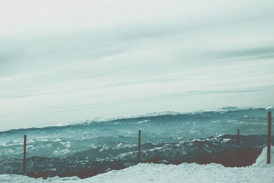 Scenic view of snow covered mountains against sky